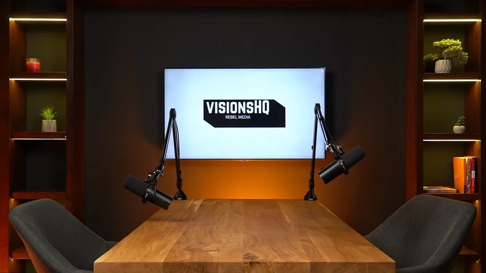 Recording setup with a table, screen and microphones