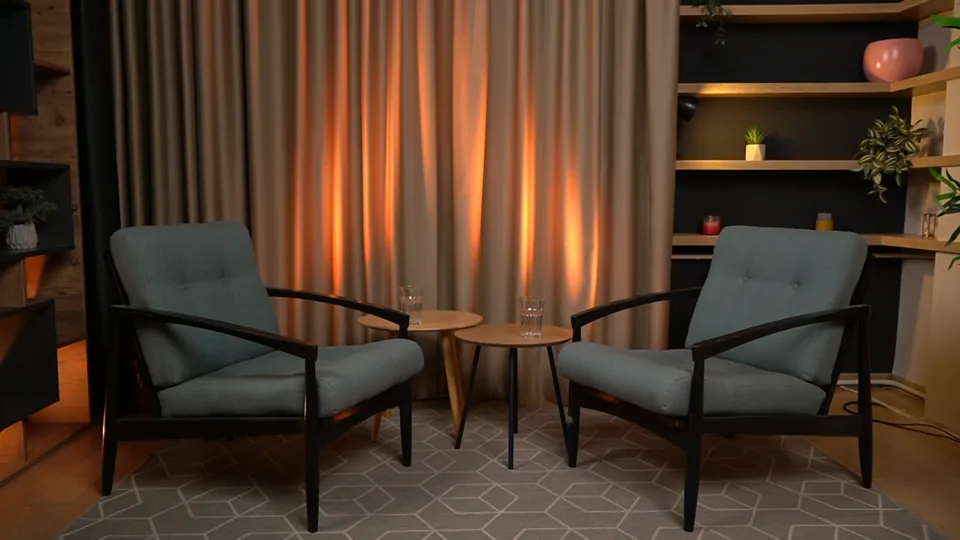 Recording setup with low armchairs and curtain
